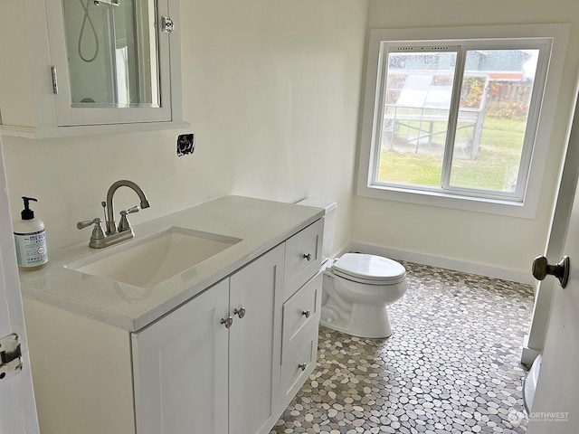 bathroom featuring tile patterned flooring, vanity, and toilet