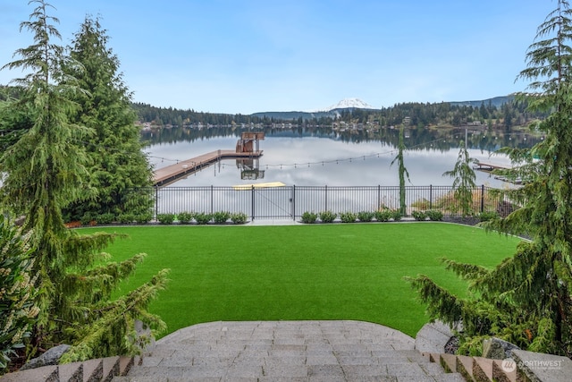 view of yard with a dock and a water view