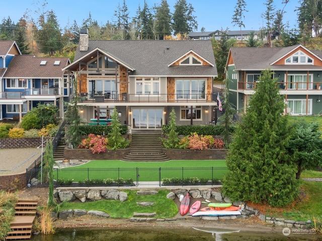 back of property featuring a yard and a balcony