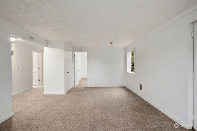 unfurnished room featuring light carpet, a textured ceiling, and ornamental molding