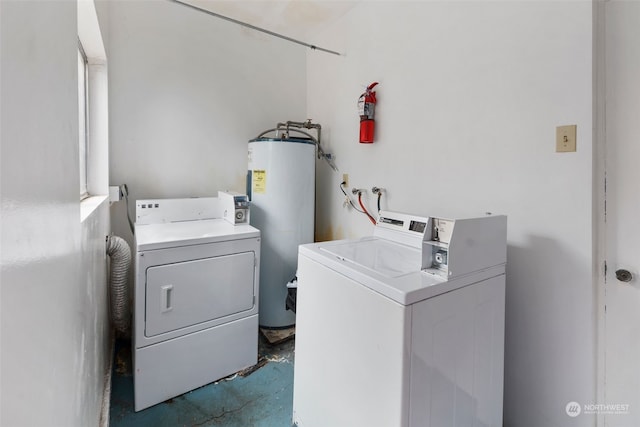 clothes washing area with independent washer and dryer and electric water heater