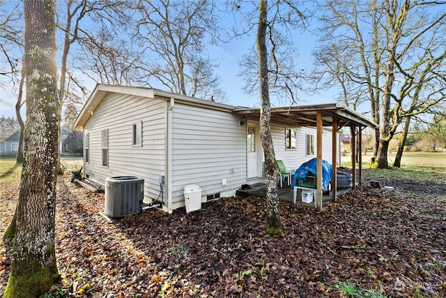 view of side of property featuring central AC