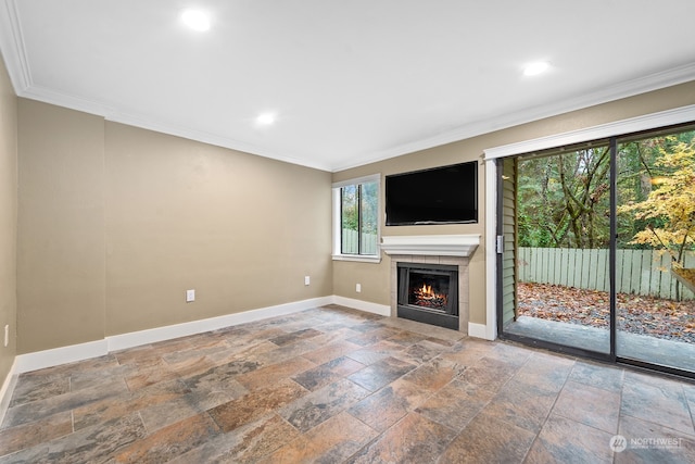 unfurnished living room featuring a tile fireplace and crown molding