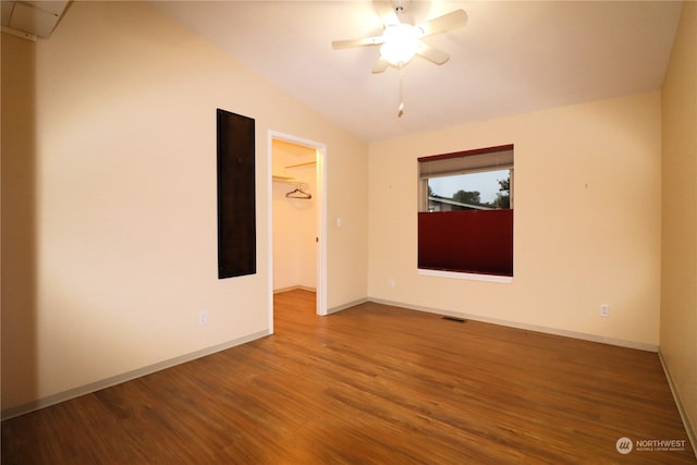 spare room featuring lofted ceiling, hardwood / wood-style flooring, and ceiling fan