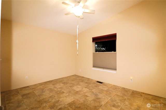 spare room with ceiling fan and vaulted ceiling