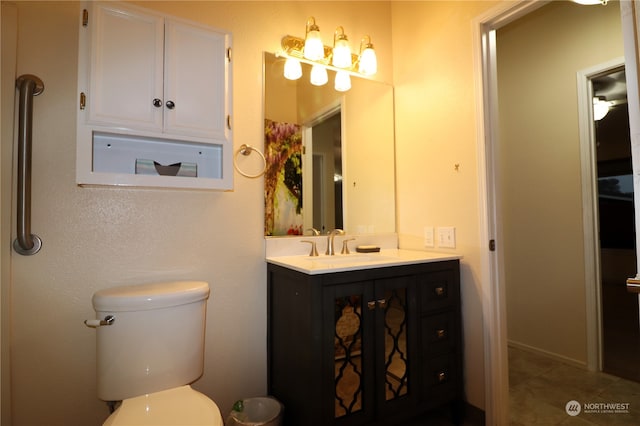 bathroom featuring tile patterned flooring, vanity, and toilet