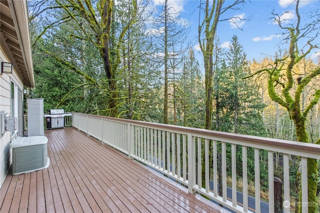 wooden deck featuring a grill