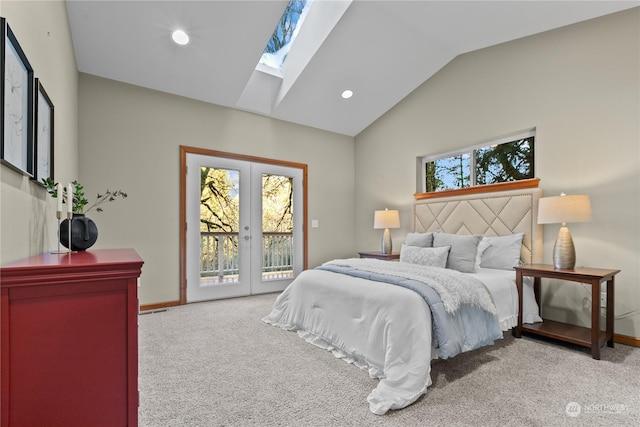 carpeted bedroom with vaulted ceiling, access to exterior, french doors, and multiple windows