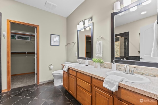 bathroom with tile patterned floors, vanity, toilet, and a shower with door