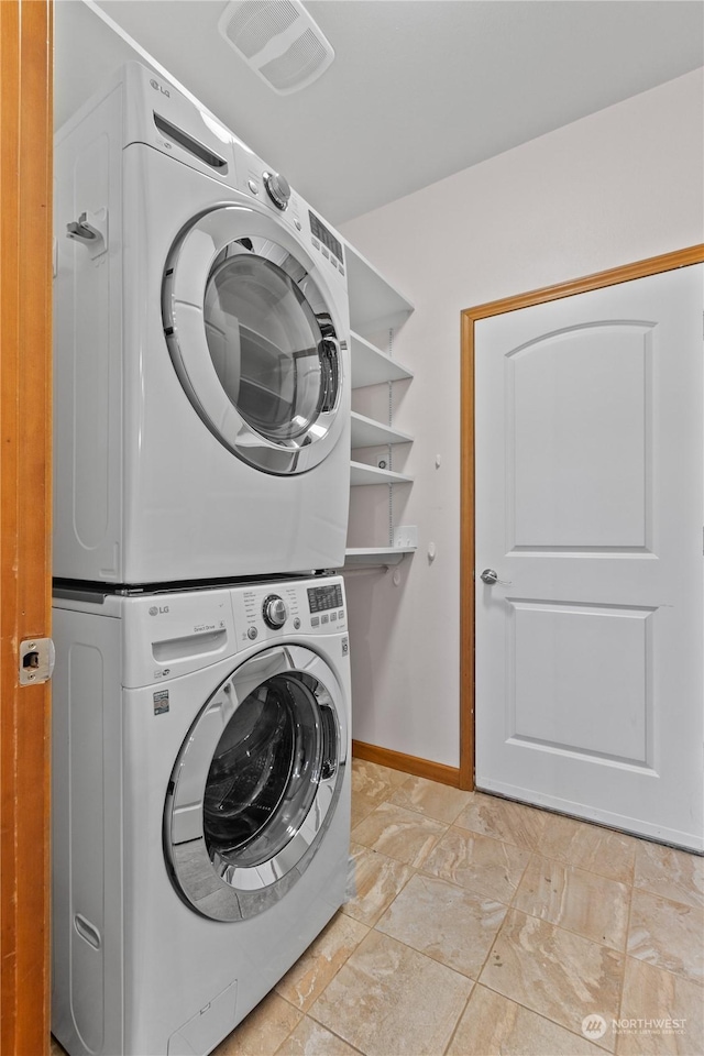 clothes washing area with stacked washer and dryer