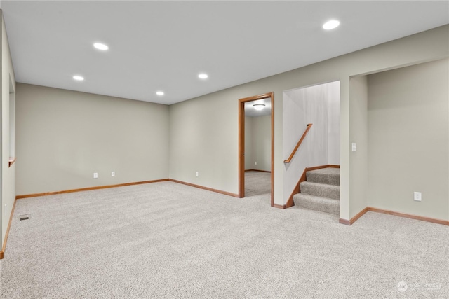 basement featuring light carpet