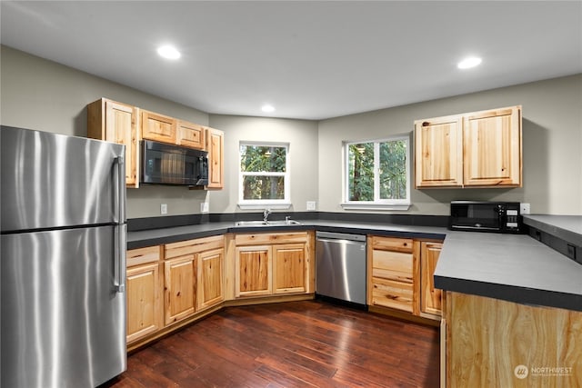 kitchen featuring light brown cabinetry, dark hardwood / wood-style flooring, stainless steel appliances, and sink