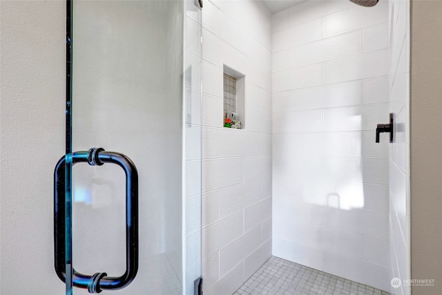 bathroom featuring a shower with door