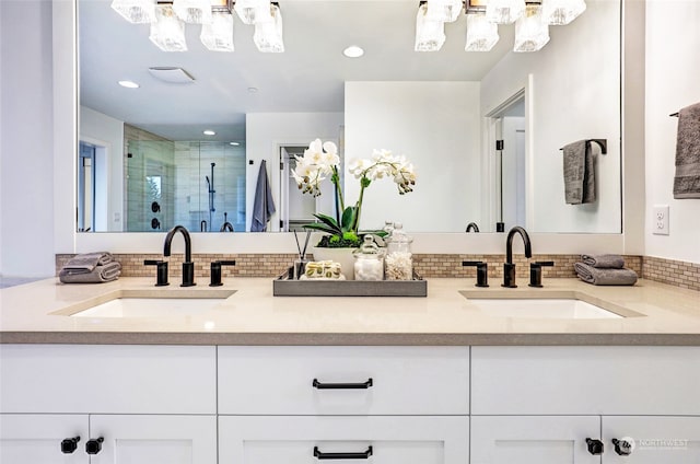 bathroom featuring vanity, an inviting chandelier, and walk in shower