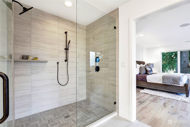 bathroom featuring an enclosed shower and hardwood / wood-style flooring