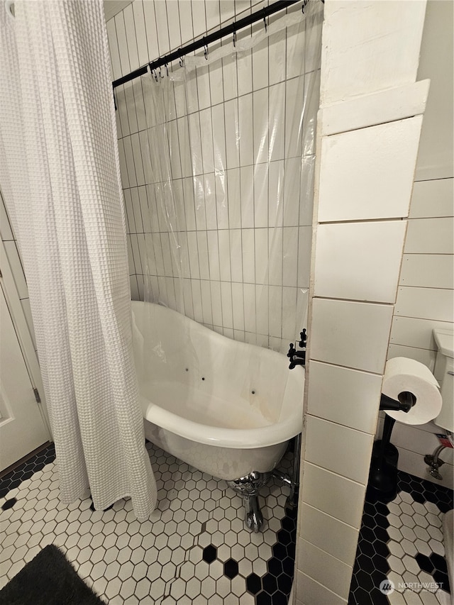 bathroom featuring tile patterned flooring and shower / bath combo