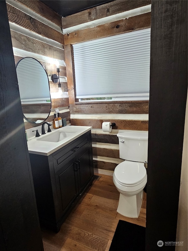 bathroom featuring hardwood / wood-style flooring, vanity, and toilet