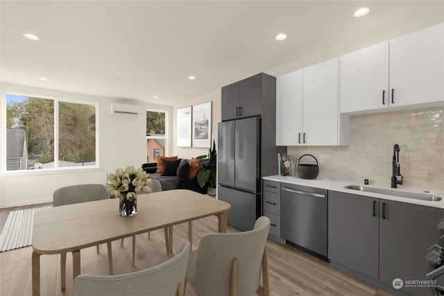 kitchen featuring appliances with stainless steel finishes, gray cabinets, white cabinetry, and sink