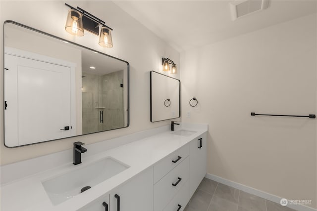 full bathroom with double vanity, a shower stall, visible vents, and a sink