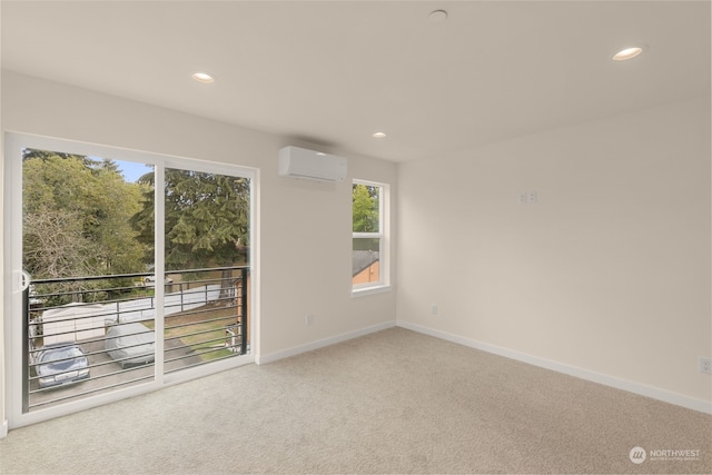 spare room featuring recessed lighting, baseboards, carpet flooring, and a wall mounted air conditioner