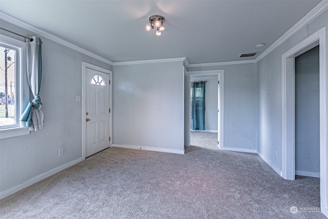 carpeted entrance foyer featuring ornamental molding