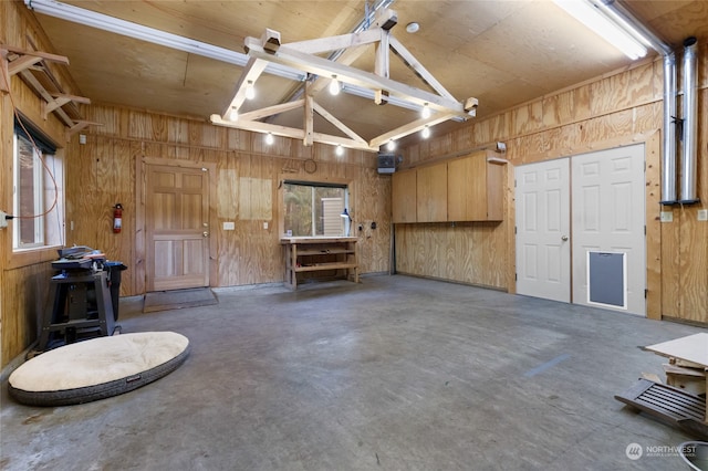 garage featuring wood walls