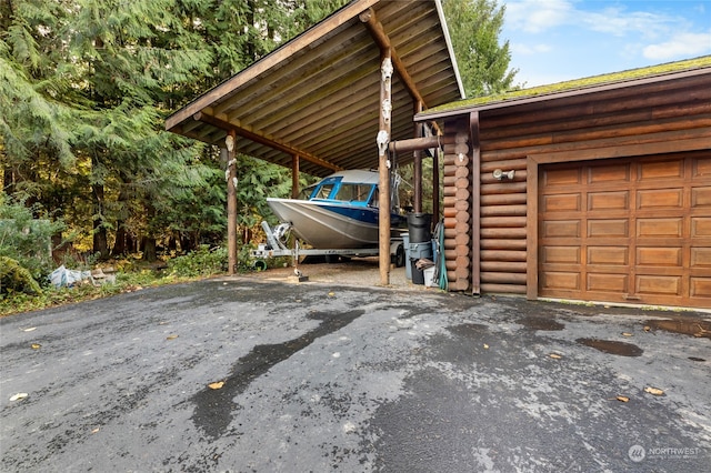 view of vehicle parking with a garage