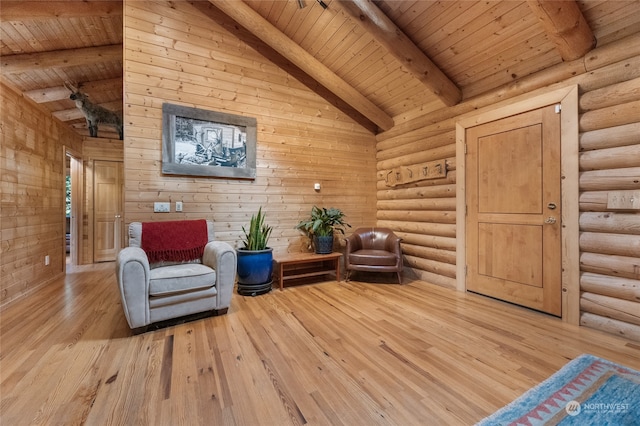 unfurnished room featuring light wood-type flooring, lofted ceiling with beams, wooden ceiling, and log walls