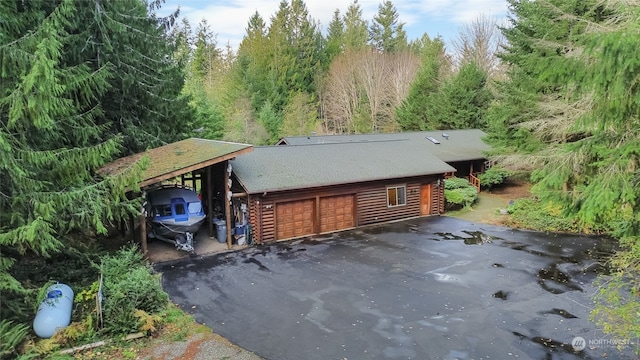 exterior space with a garage and a carport