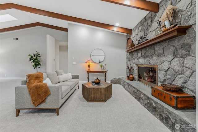 living room featuring a stone fireplace, light carpet, and lofted ceiling with beams