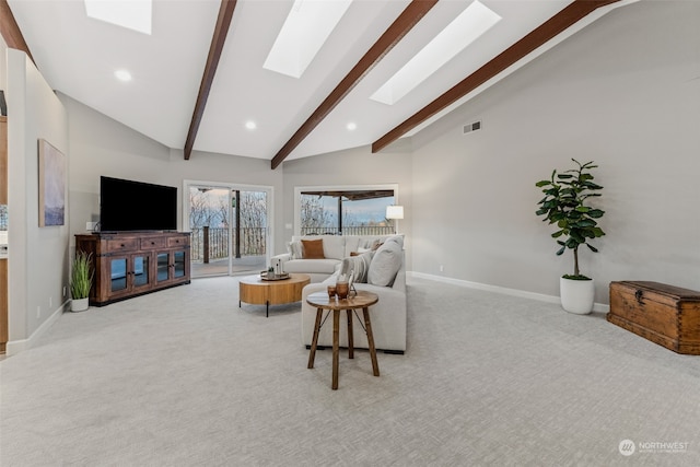 carpeted living room featuring a skylight, beamed ceiling, and high vaulted ceiling