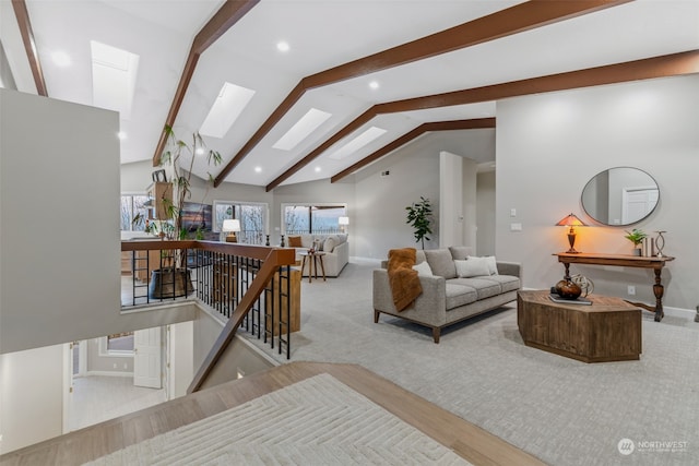 living room with light hardwood / wood-style flooring and lofted ceiling with skylight