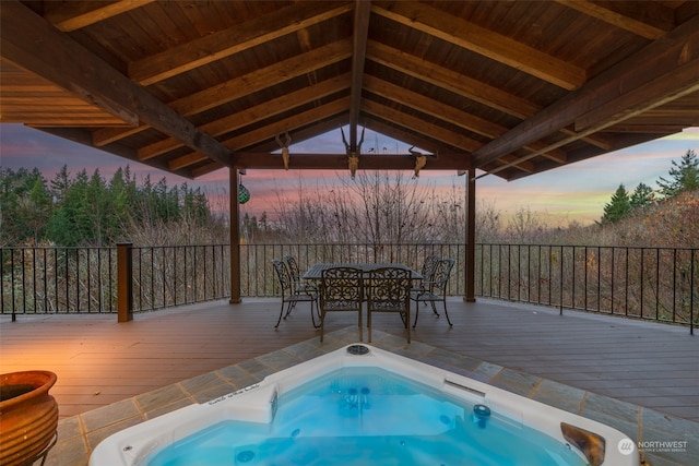 pool at dusk featuring a deck