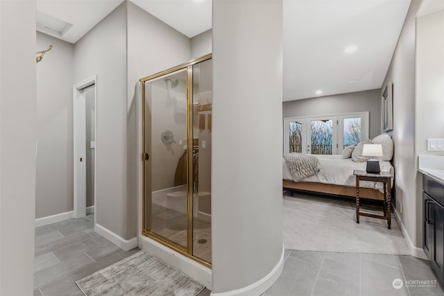 bathroom with vanity, an enclosed shower, and french doors