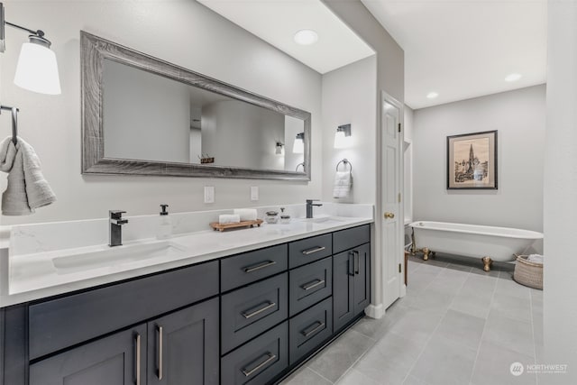 bathroom featuring tile patterned floors, a bathtub, and vanity