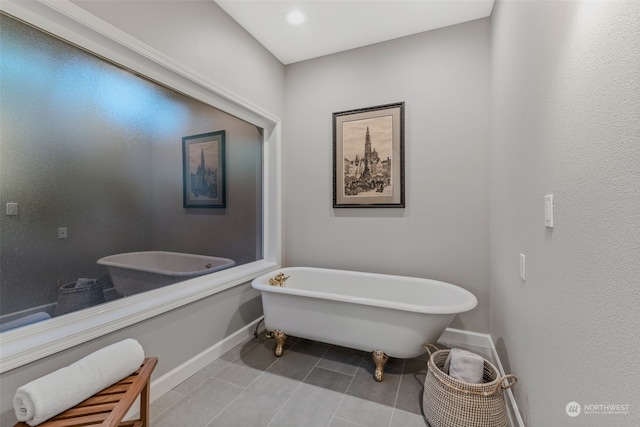 bathroom featuring tile patterned flooring and a tub to relax in