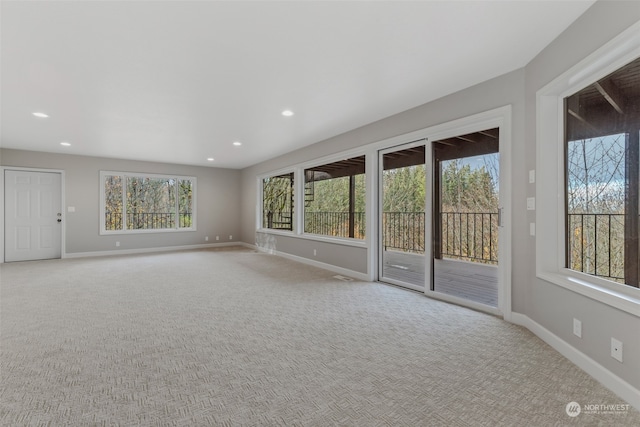 interior space featuring light carpet and a wealth of natural light