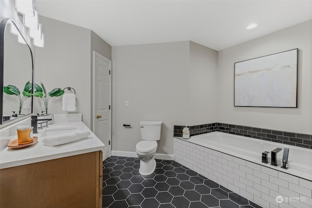 bathroom featuring tile patterned flooring, vanity, toilet, and tiled tub