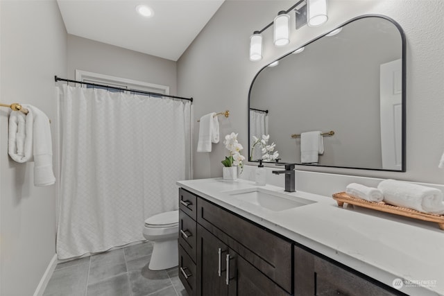 bathroom with tile patterned flooring, vanity, and toilet