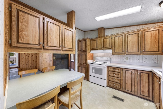 kitchen featuring a textured ceiling, crown molding, vaulted ceiling, and white electric range