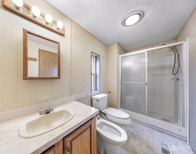 bathroom featuring walk in shower, a bidet, a textured ceiling, toilet, and vanity