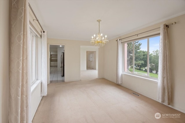 unfurnished room featuring light colored carpet, an inviting chandelier, and crown molding