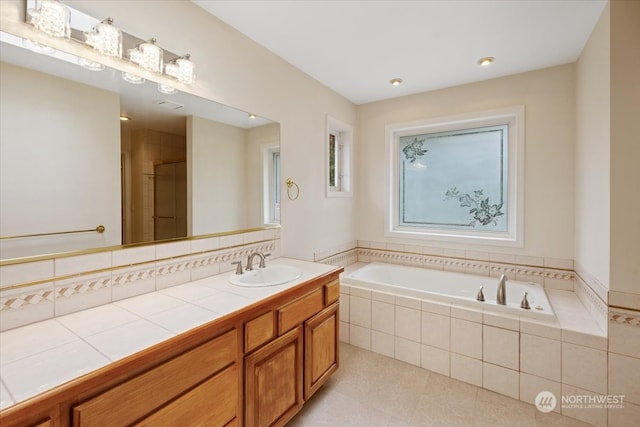 bathroom with vanity and independent shower and bath