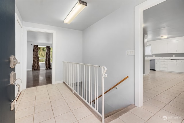 hall with light tile patterned floors