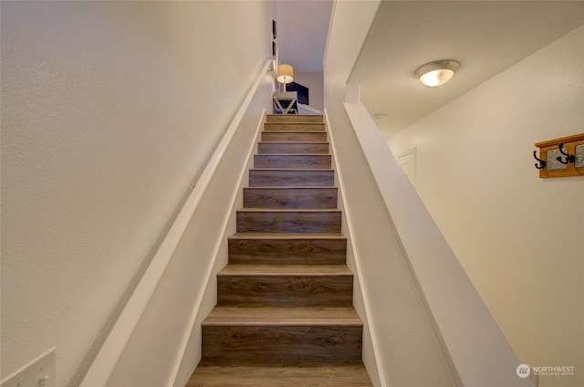 stairs featuring hardwood / wood-style flooring