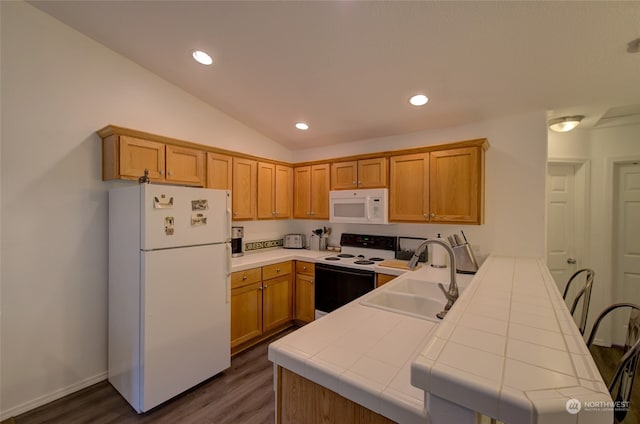 kitchen featuring sink, dark hardwood / wood-style floors, kitchen peninsula, tile countertops, and white appliances