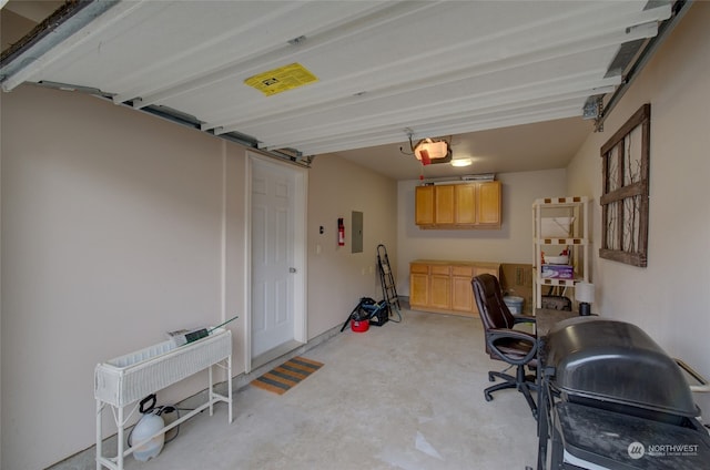 garage featuring electric panel and a garage door opener