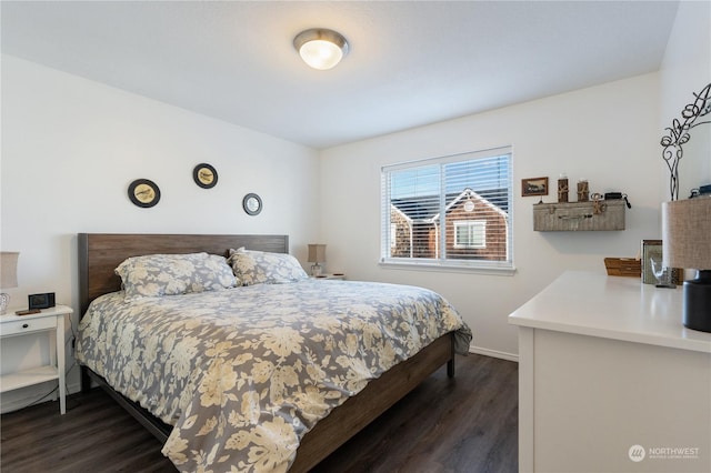 bedroom with dark hardwood / wood-style floors