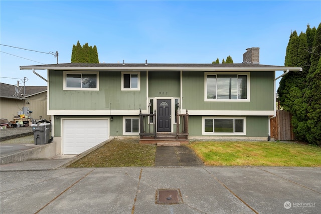 bi-level home featuring a front lawn and a garage