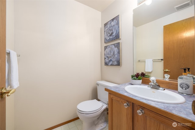 bathroom featuring toilet and vanity